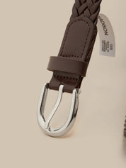 Brown braided leather belt with silver buckle on a beige background