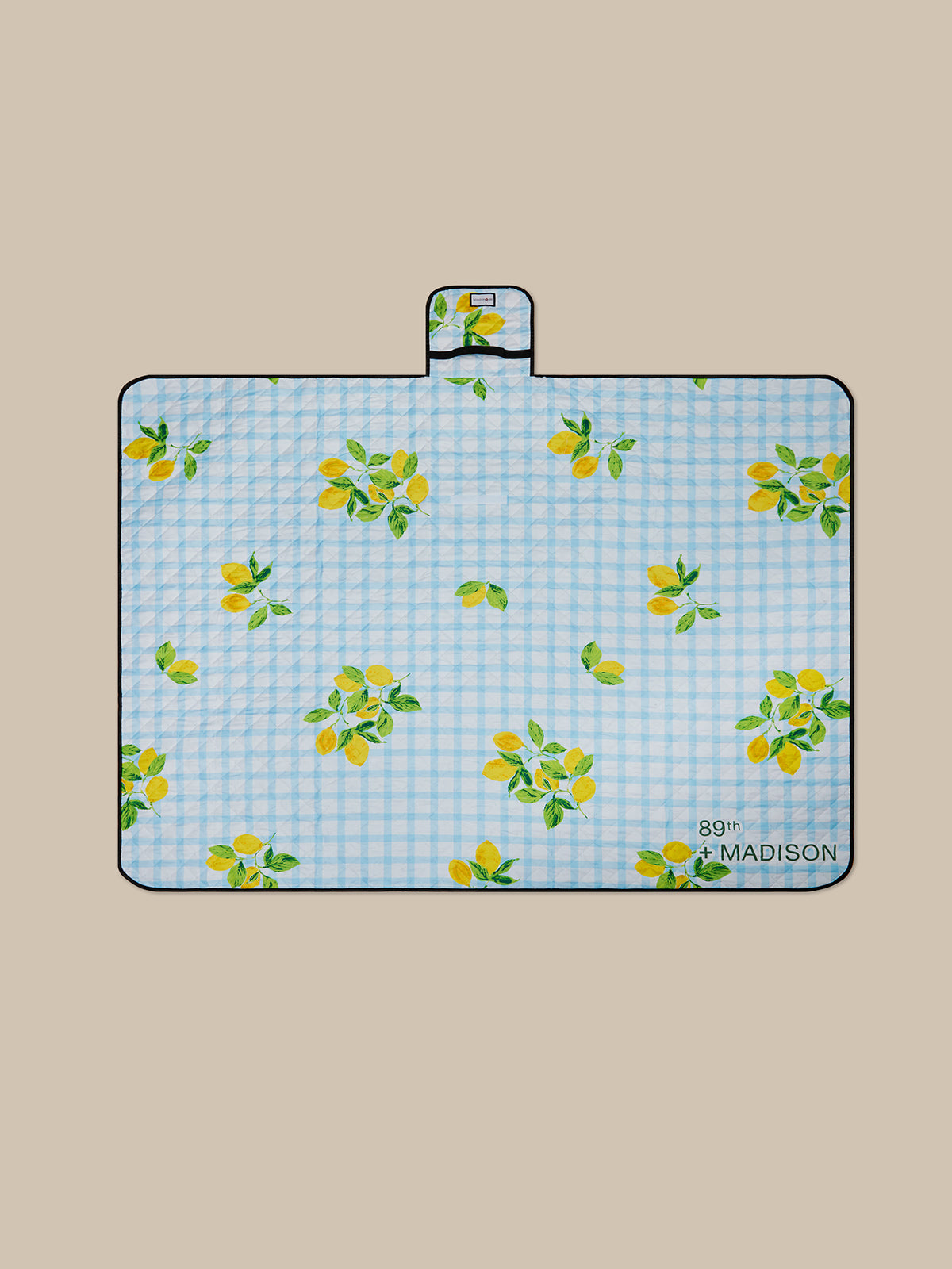 Floral-patterned mat with '89th Madison' branding on a beige background