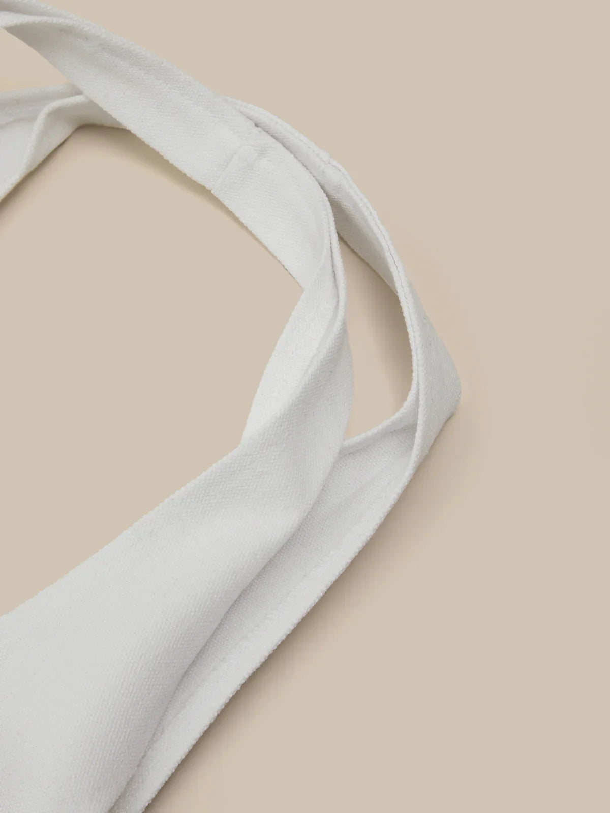Light white fabric strap on a beige background