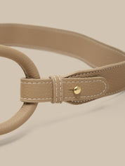 Beige belt with a gold buckle on a beige background