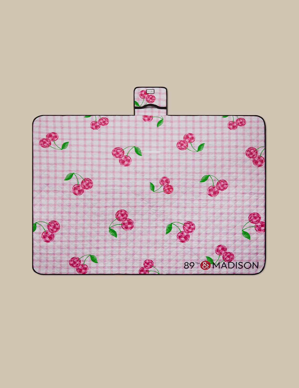 Pink checkered mat with cherry pattern on a beige background