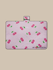 Pink checkered mat with cherry pattern on a beige background