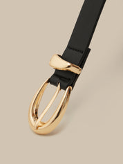 Black belt with a gold buckle on a beige background