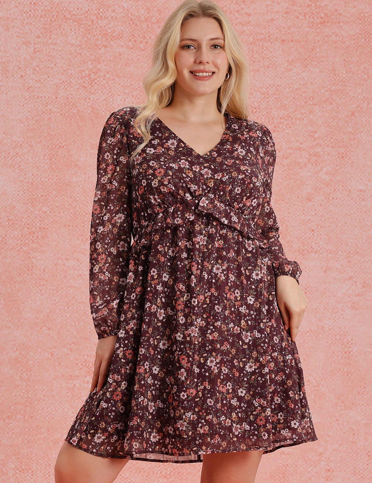 Woman wearing a floral dress against a pink background