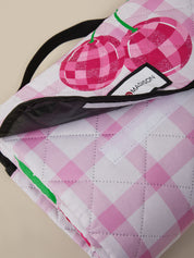 Pink and white checkered bag with cherry design and Maison label.
