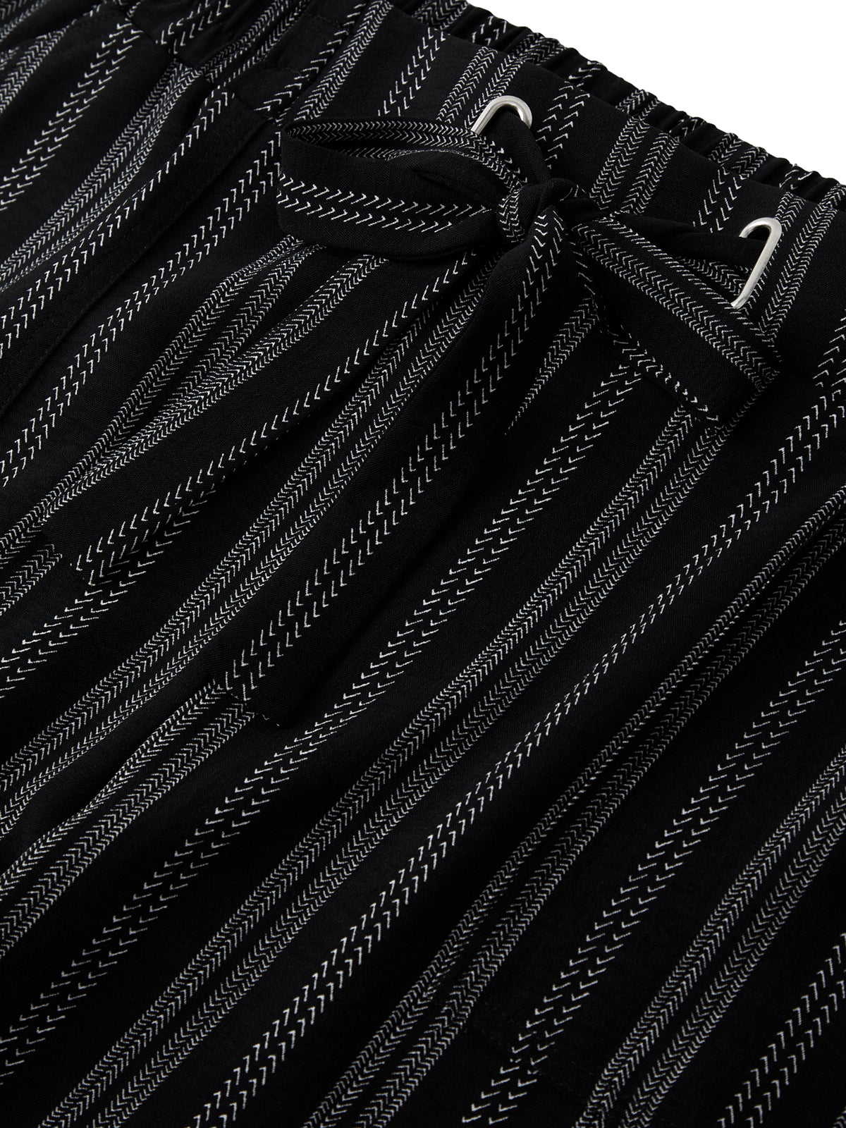 Close-up of black pants with white stripes and drawstring