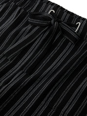 Close-up of black pants with white stripes and drawstring