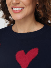 Navy sweater with a red heart design worn by a person.