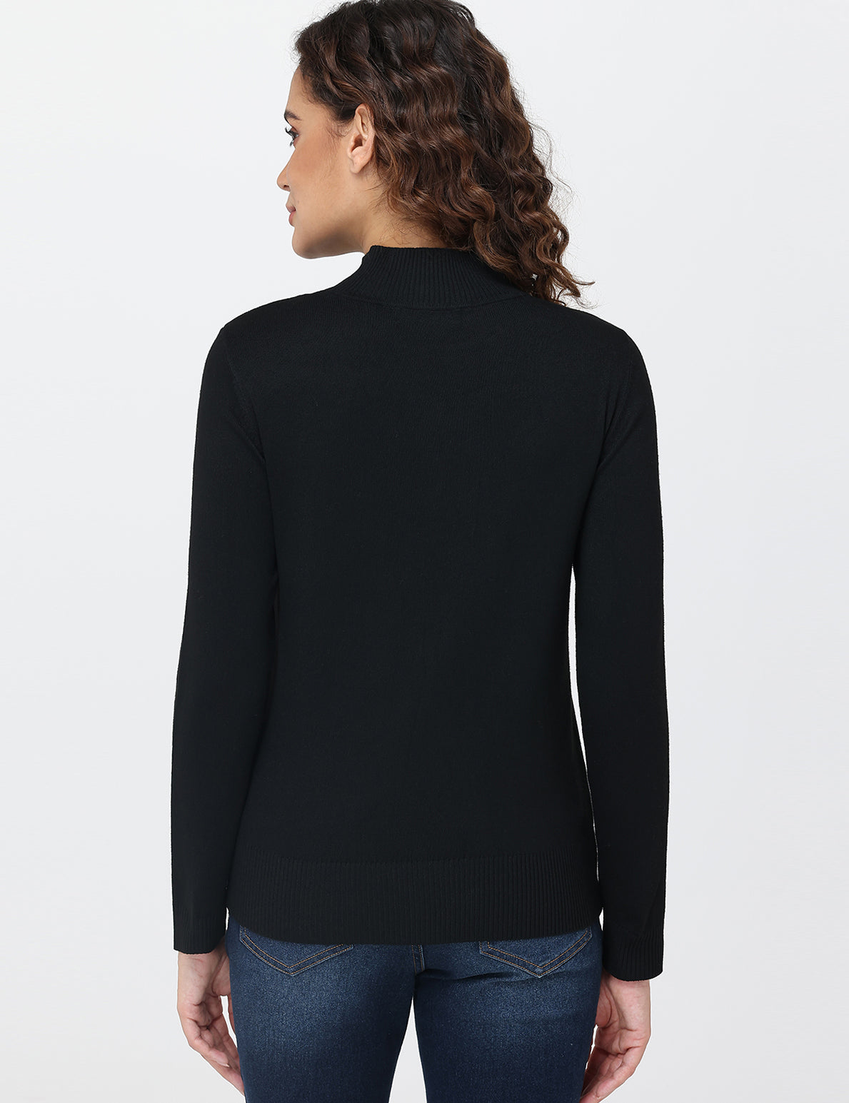 Woman wearing a black long-sleeve top on a white background