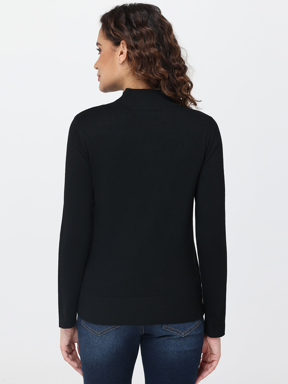Woman wearing a black long-sleeve top on a white background