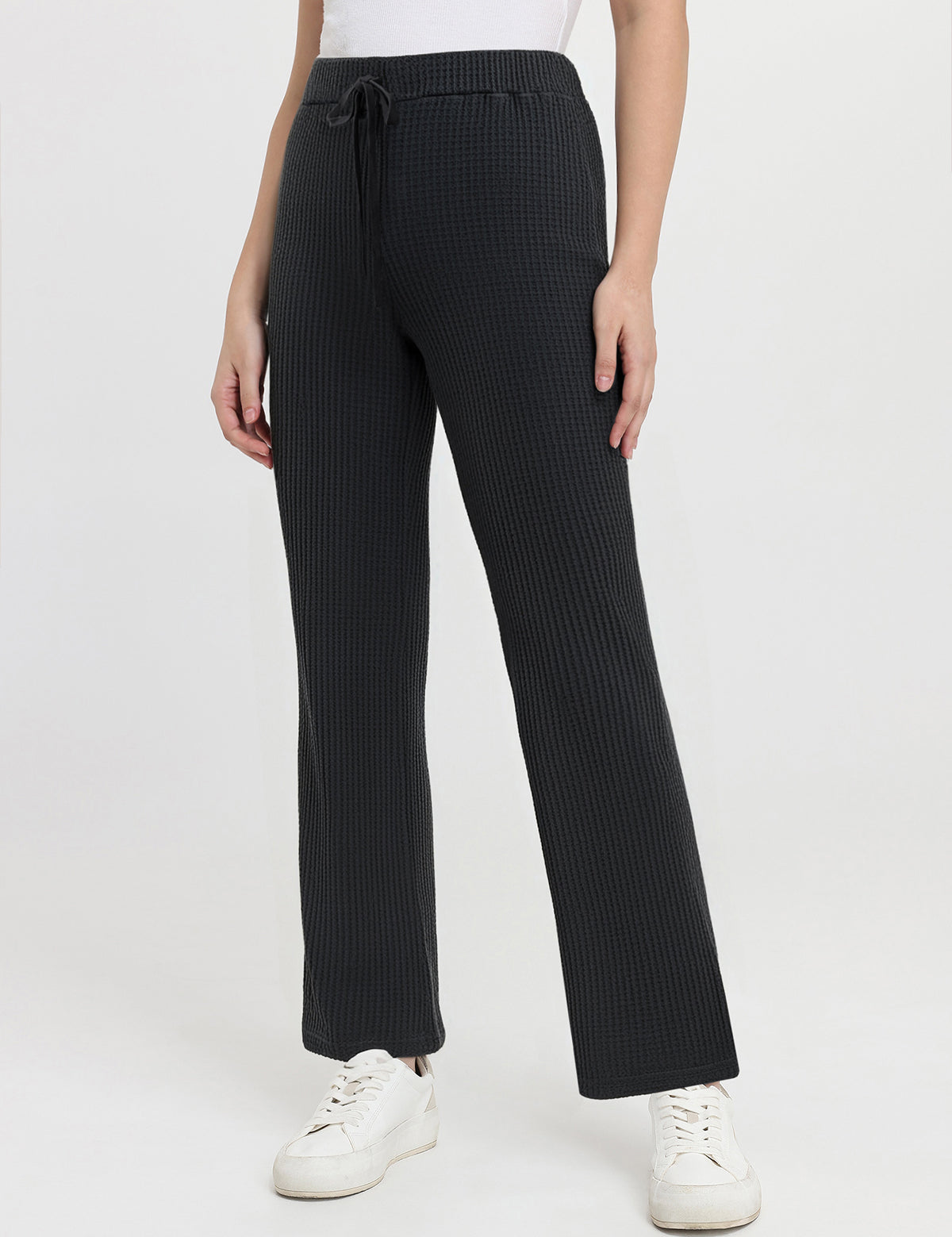 Black waffle pants worn by a person on a white background