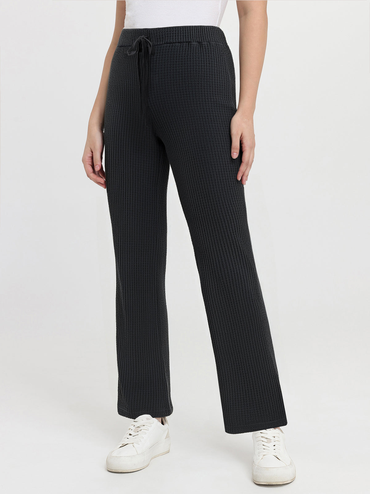 Black waffle pants worn by a person on a white background