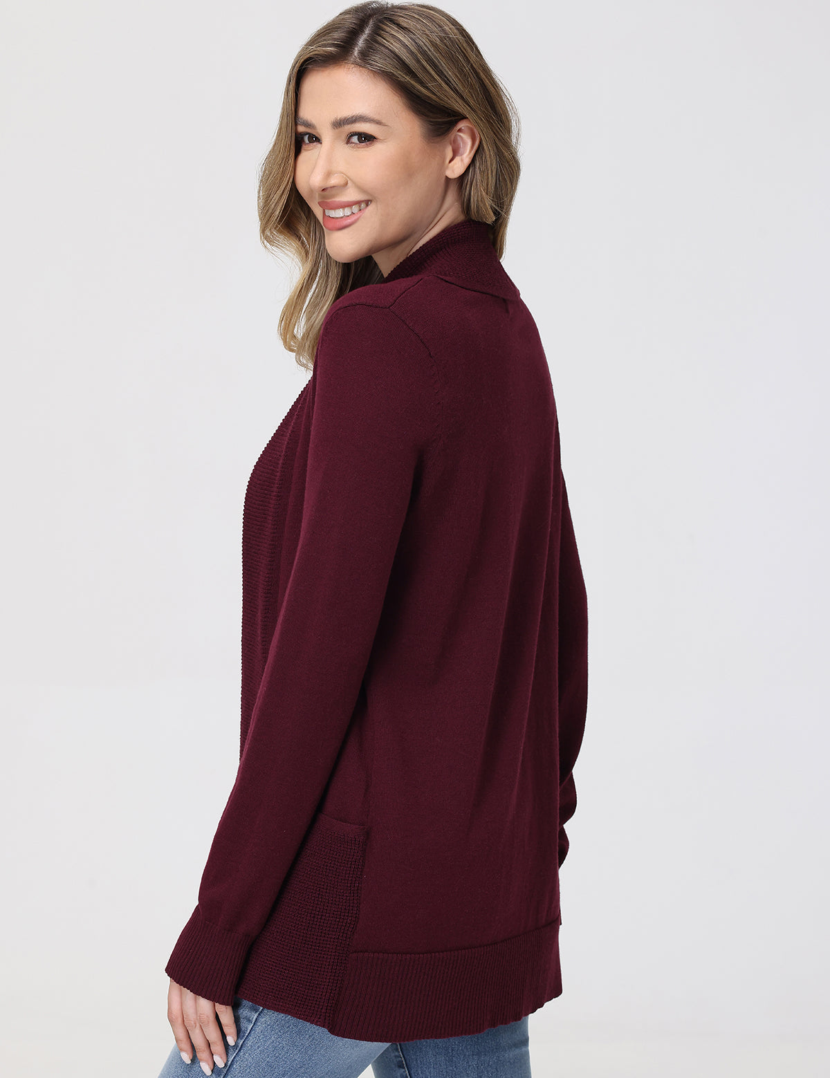 Woman wearing a burgundy cardigan on a white background