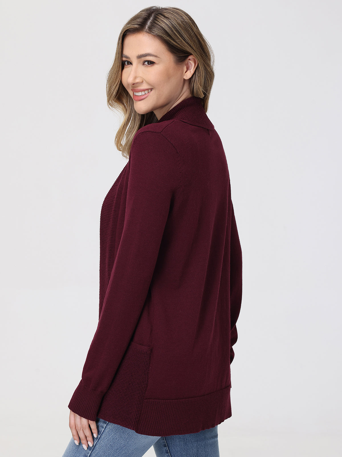 Woman wearing a burgundy cardigan on a white background