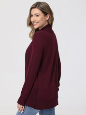 Woman wearing a burgundy cardigan on a white background