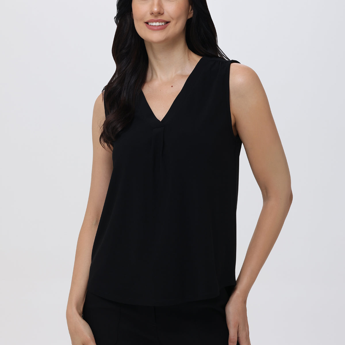 A woman wearing a black V-neck sleeveless tank top.