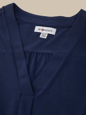 Navy blue garment with a brand label on a beige background
