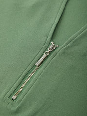 Close-up of a silver zipper on a green jacket