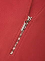 Close-up of a red garment featuring a silver metal zipper with a rectangular pull tab.