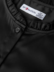 Close-up of a black garment with a 'Madison' label on a dark background