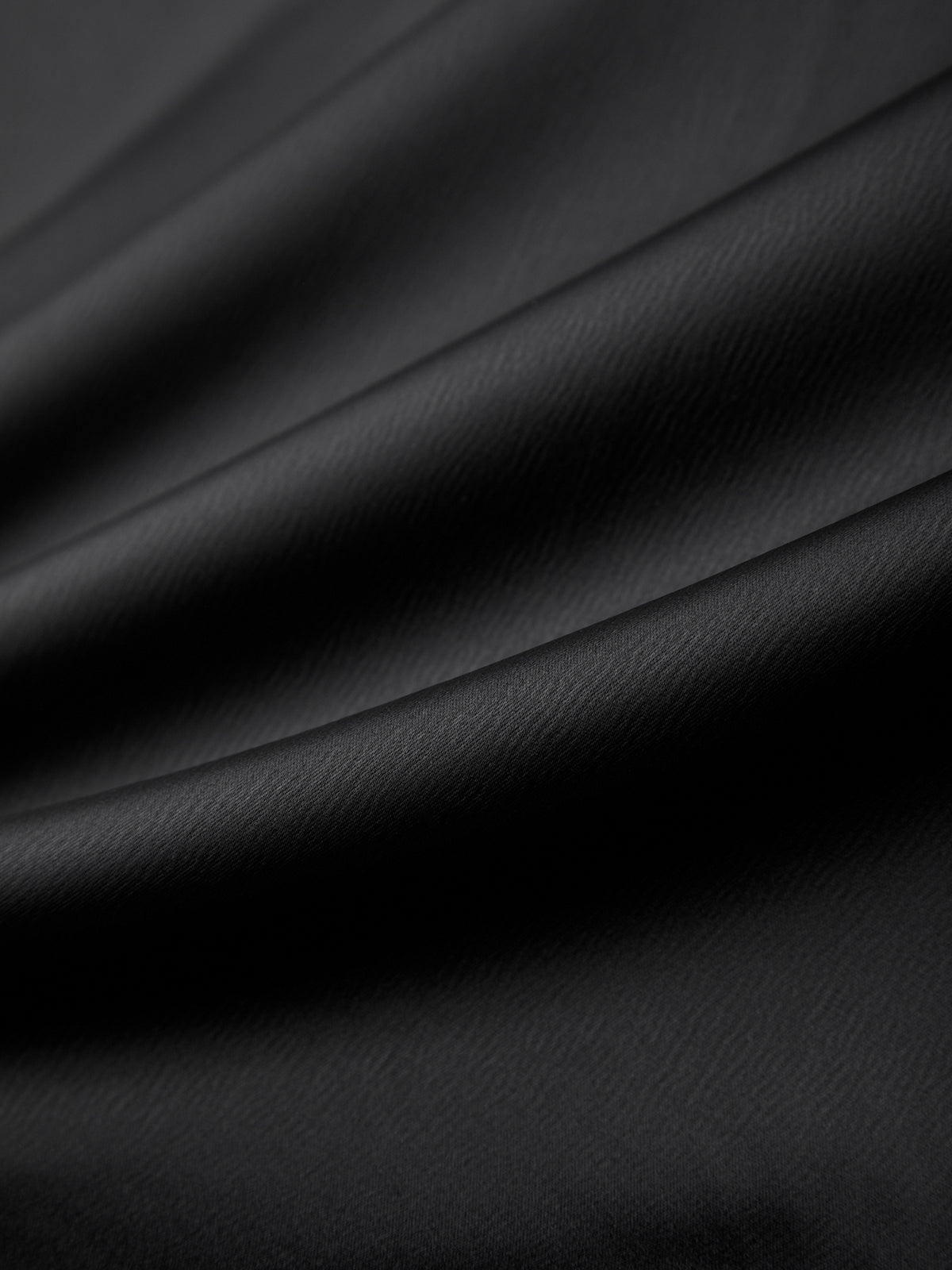 Close-up of black leather fabric with a subtle texture
