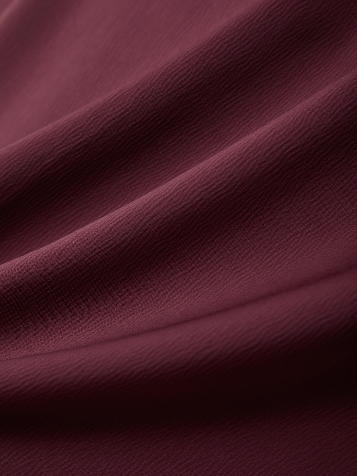 Close-up of dark purple fabric with folds