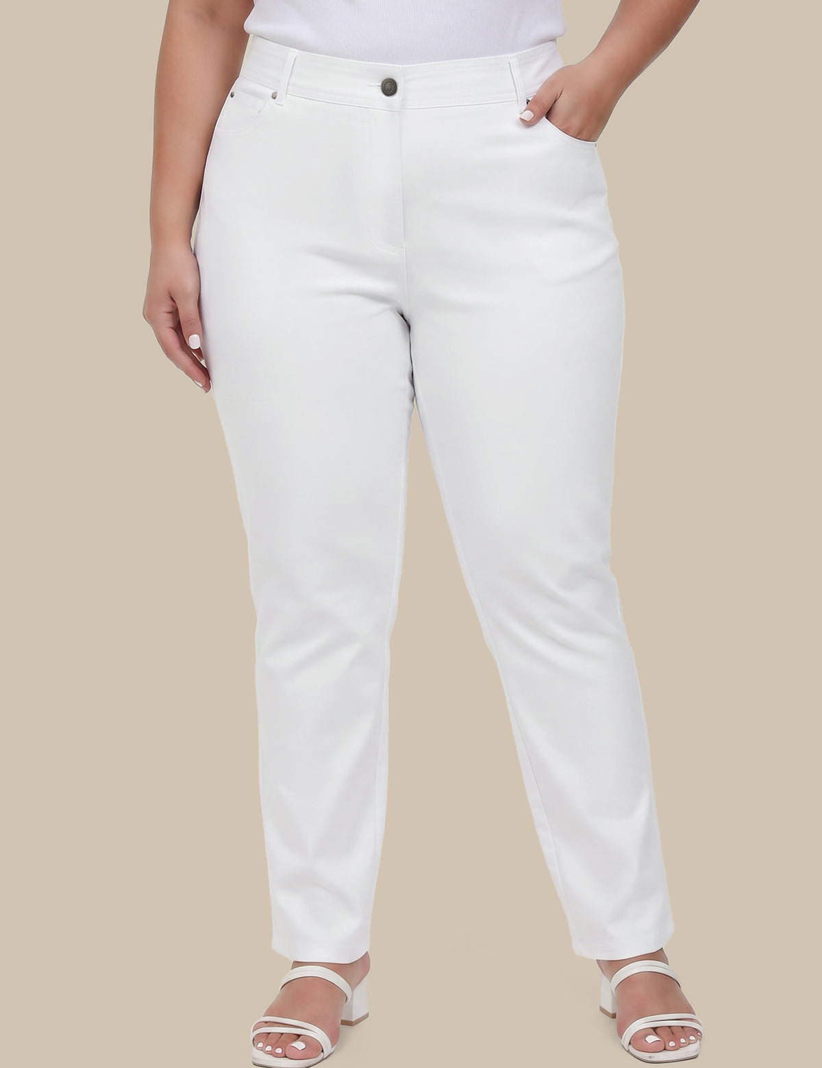 Person wearing white pants on a beige background