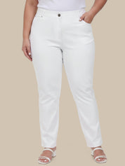 Person wearing white pants on a beige background