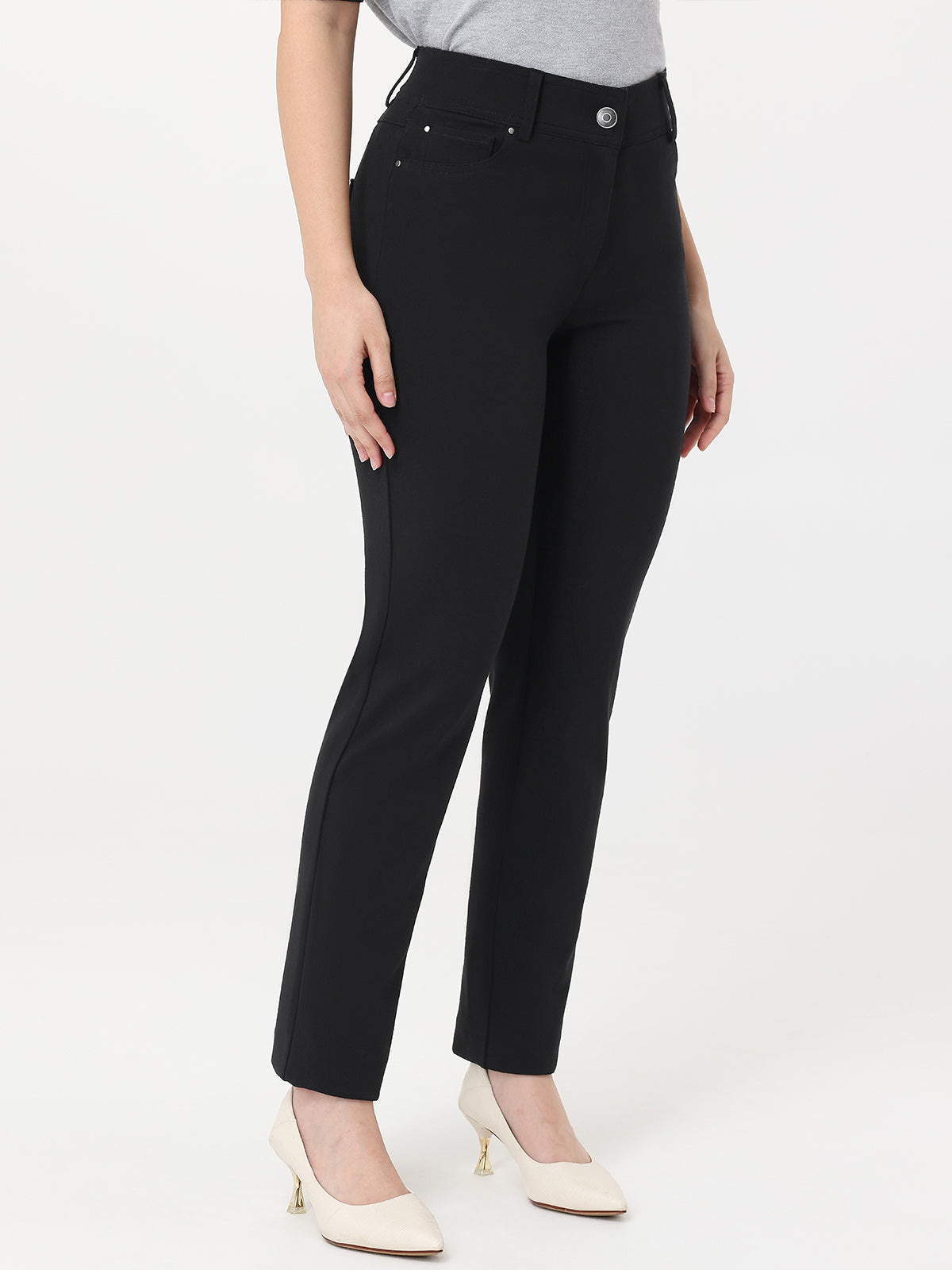 Person wearing black pants on a white background