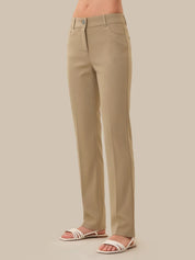 Beige pants worn by a person on a beige background