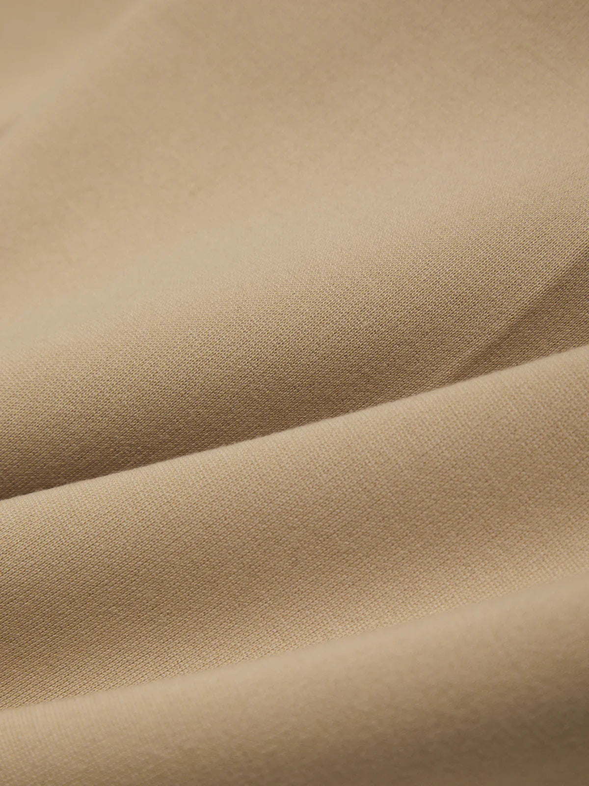 Close-up of beige fabric with folds