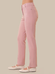 Pink pants worn by a person on a beige background