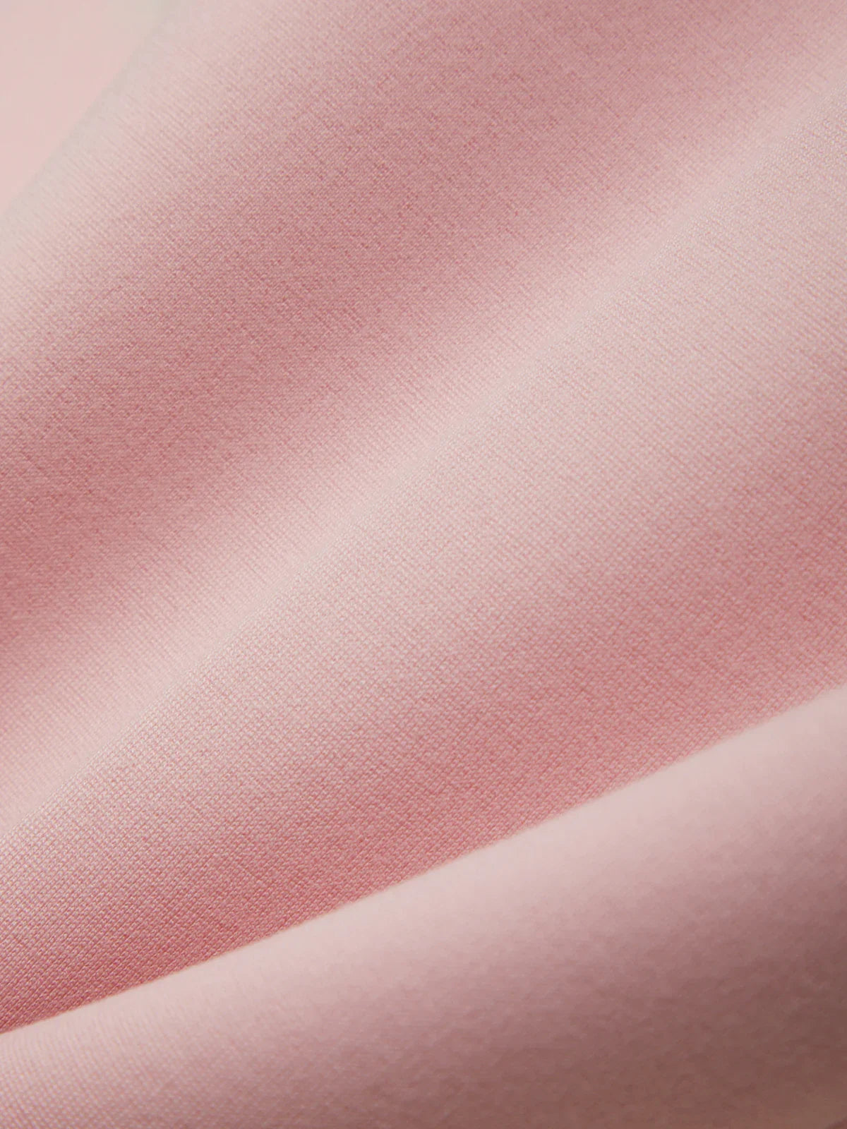 Close-up of pink fabric with a subtle texture