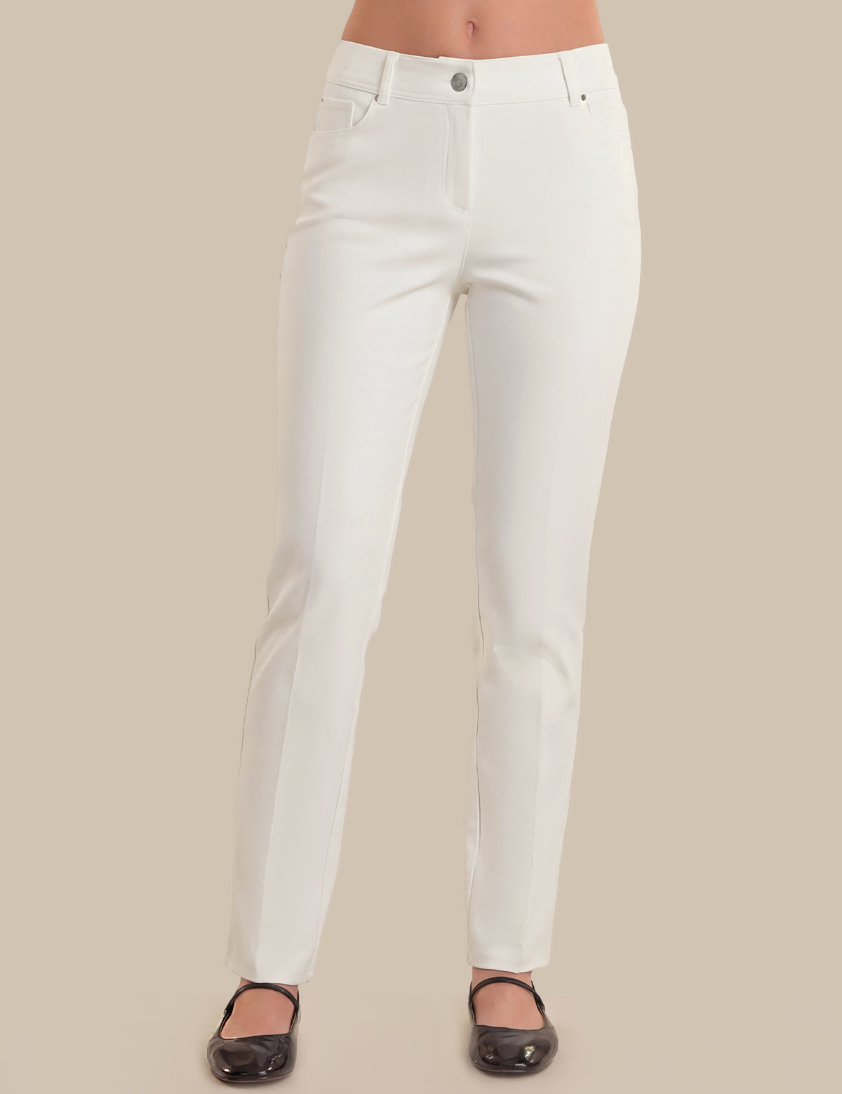 White pants worn by a person on a beige background