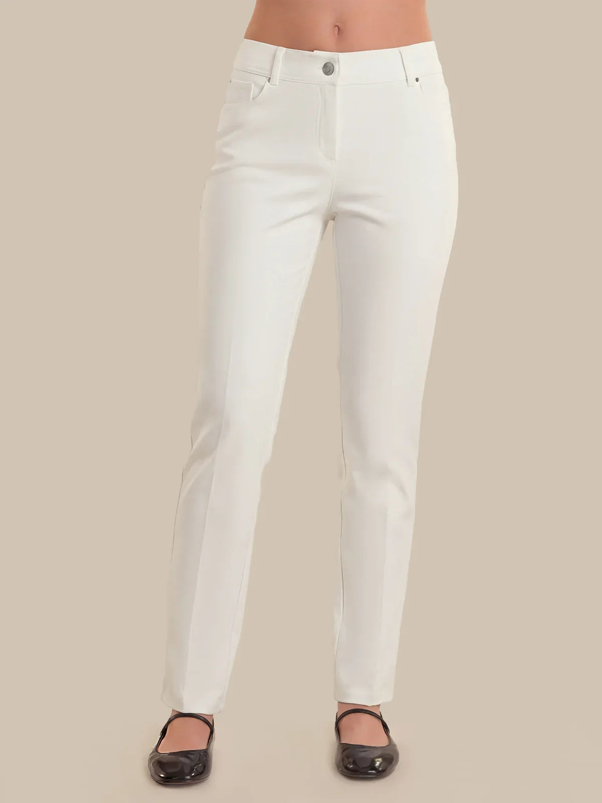 White pants worn by a person on a beige background