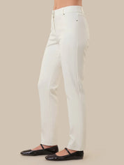 White pants worn by a person on a beige background