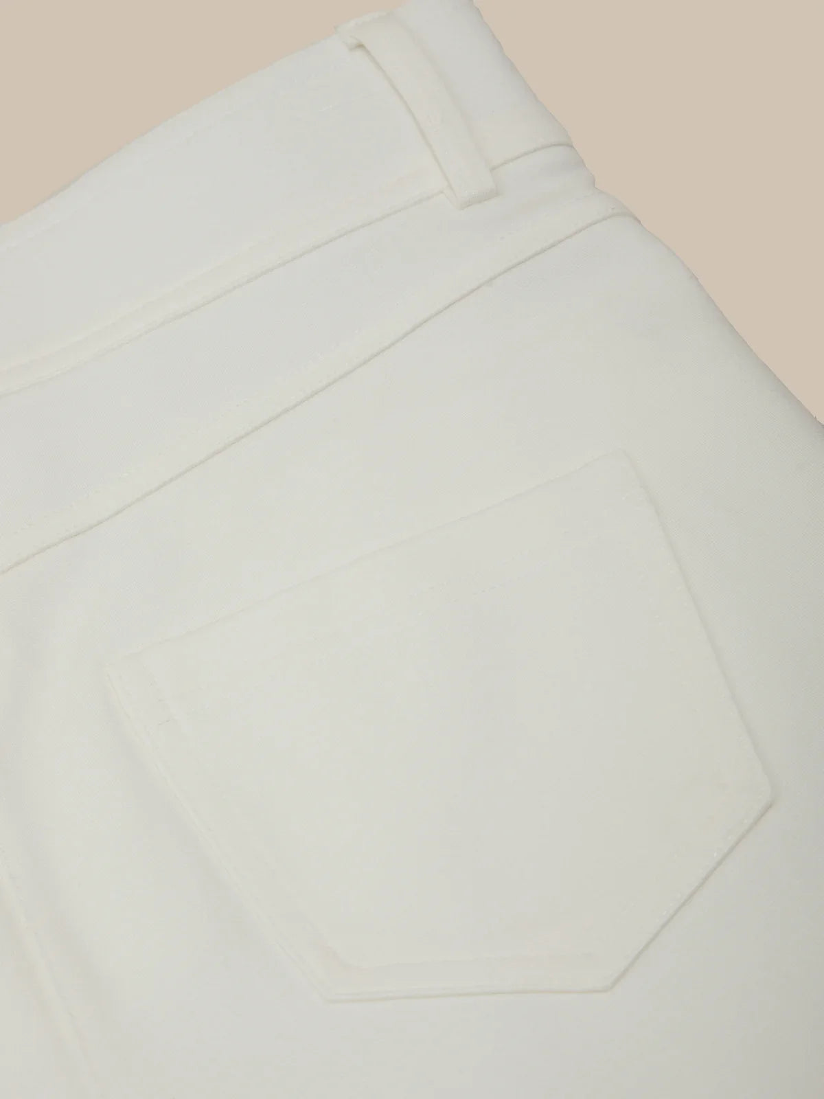 Close-up of light gray pants on a beige background