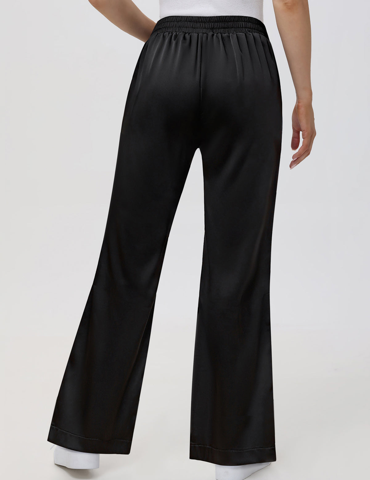Black wide-leg pants worn by a person on a white background