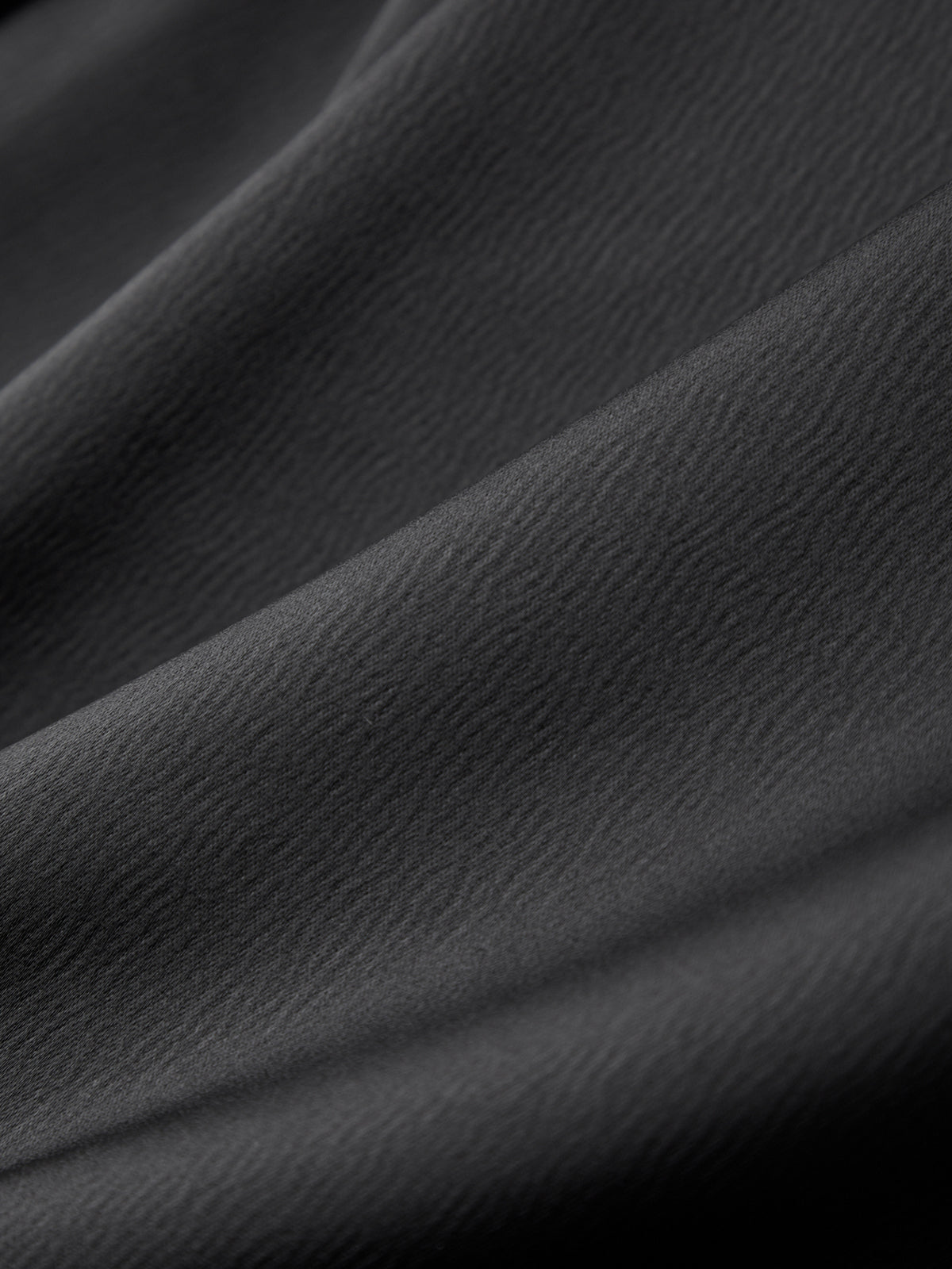 Close-up of dark gray fabric with visible texture