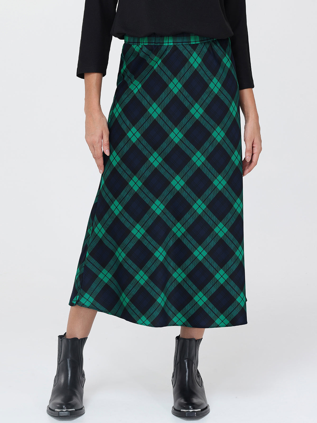 Person wearing a green and navy plaid skirt on a white background
