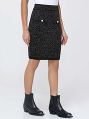 Black patterned skirt worn by a person on a white background