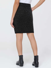 Person wearing a black patterned skirt on a white background