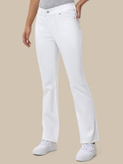 Person wearing white jeans on a beige background
