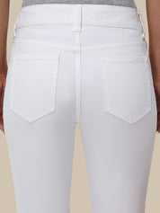 White jeans worn by a person on a beige background