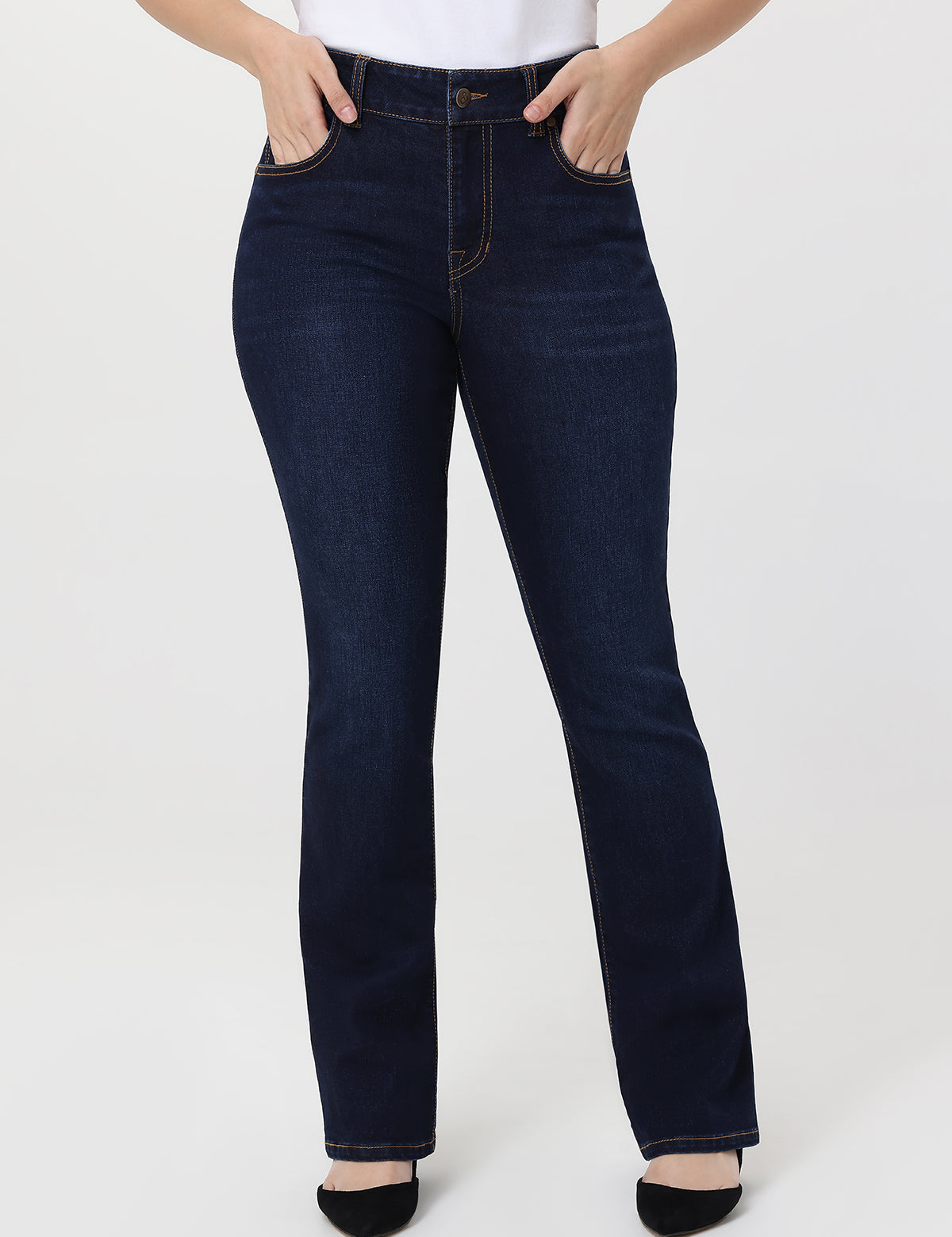 Dark blue jeans worn by a person on a white background