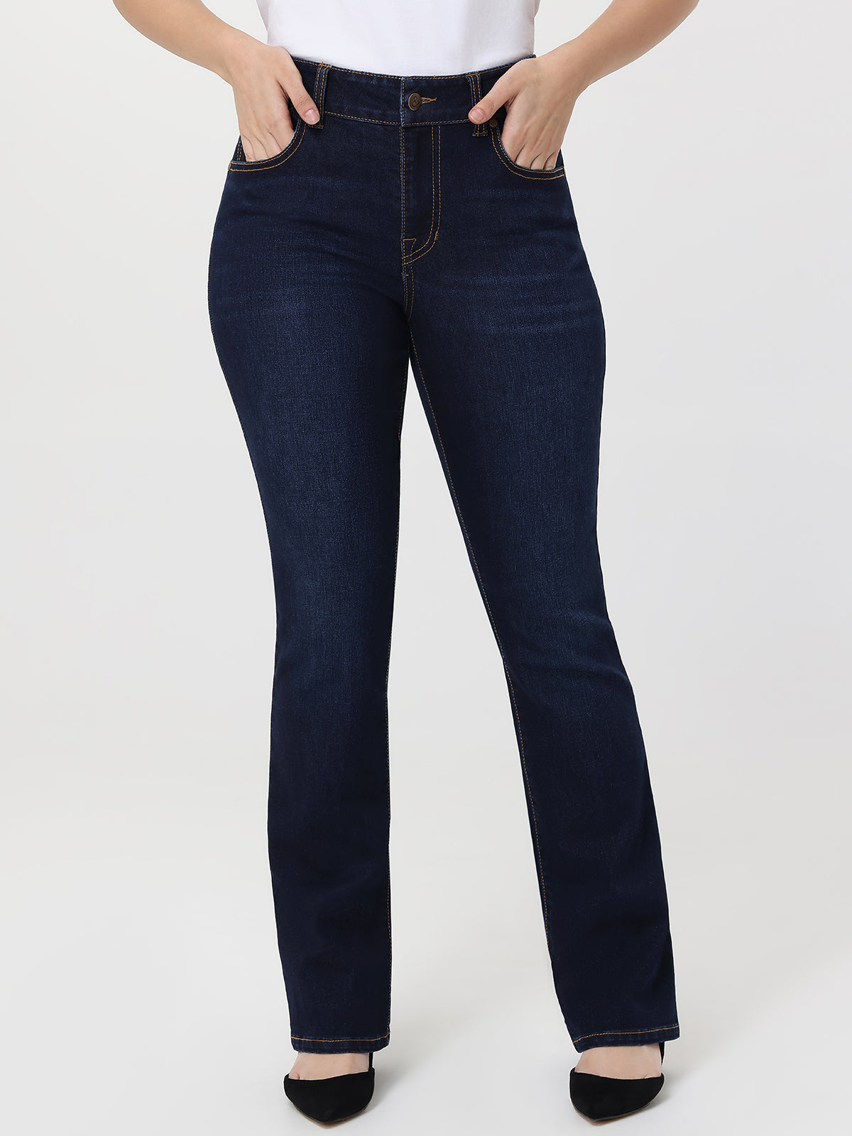 Dark blue jeans worn by a person on a white background