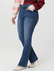 Person wearing blue flared jeans on a white background