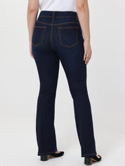 Dark blue jeans worn by a person on a white background