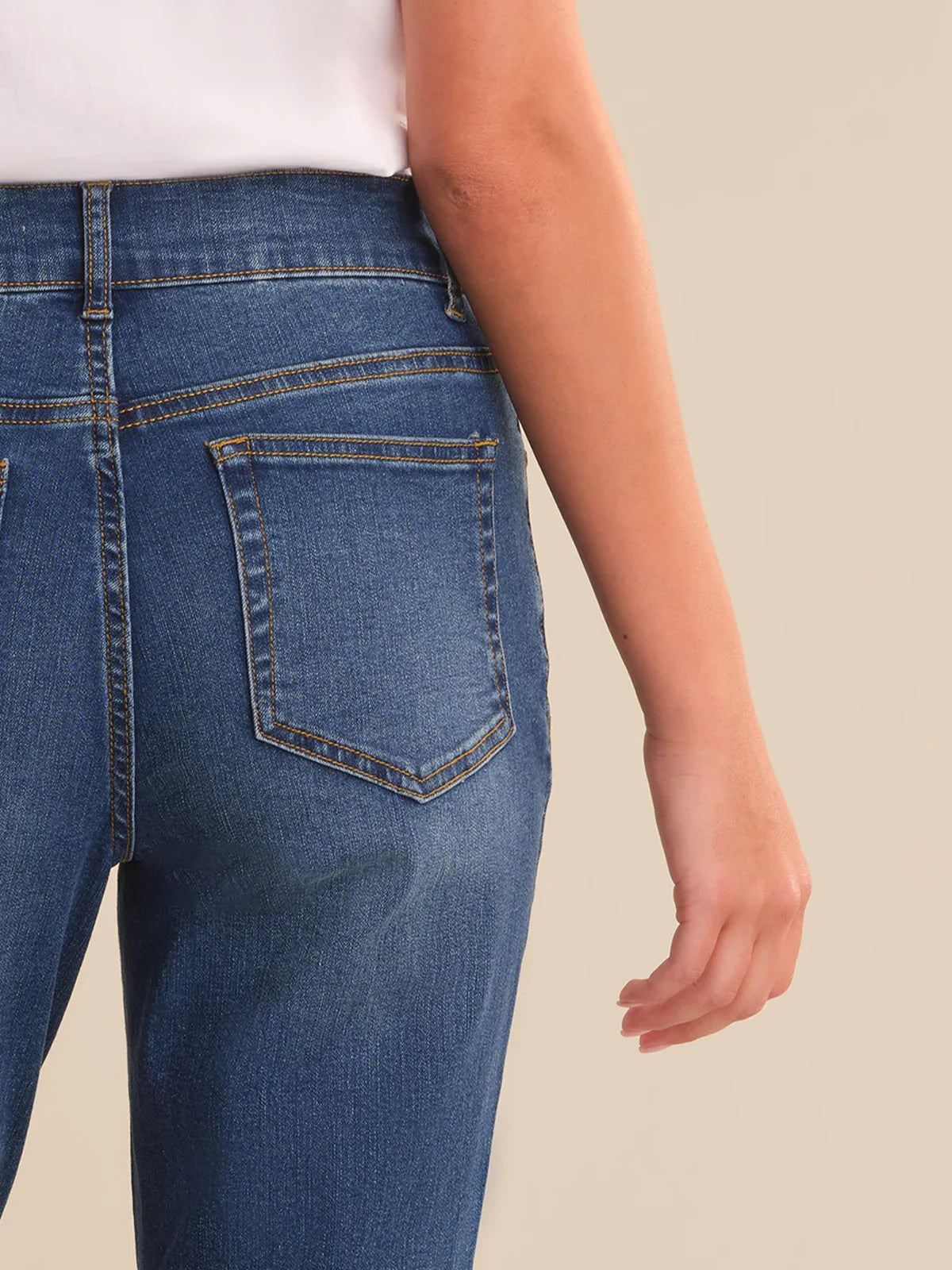 Close-up of blue jeans with a neutral background