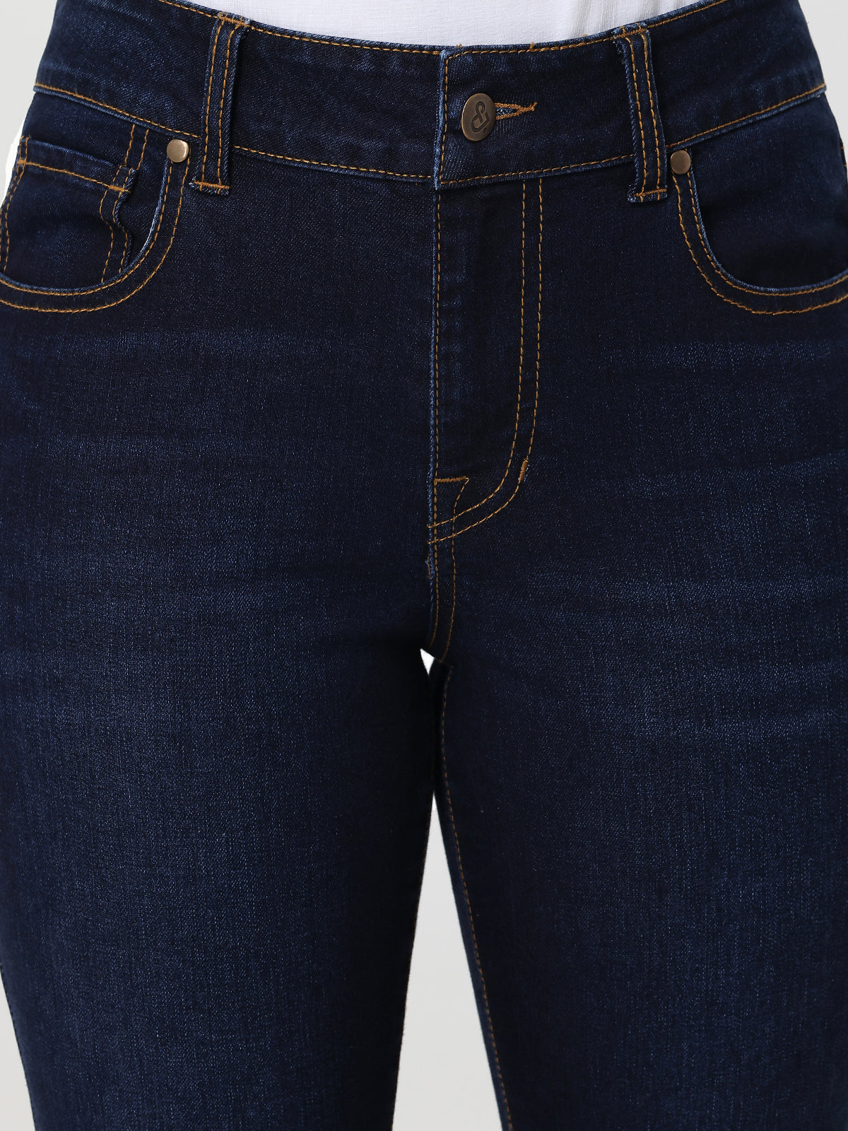Close-up of dark blue jeans on a white background